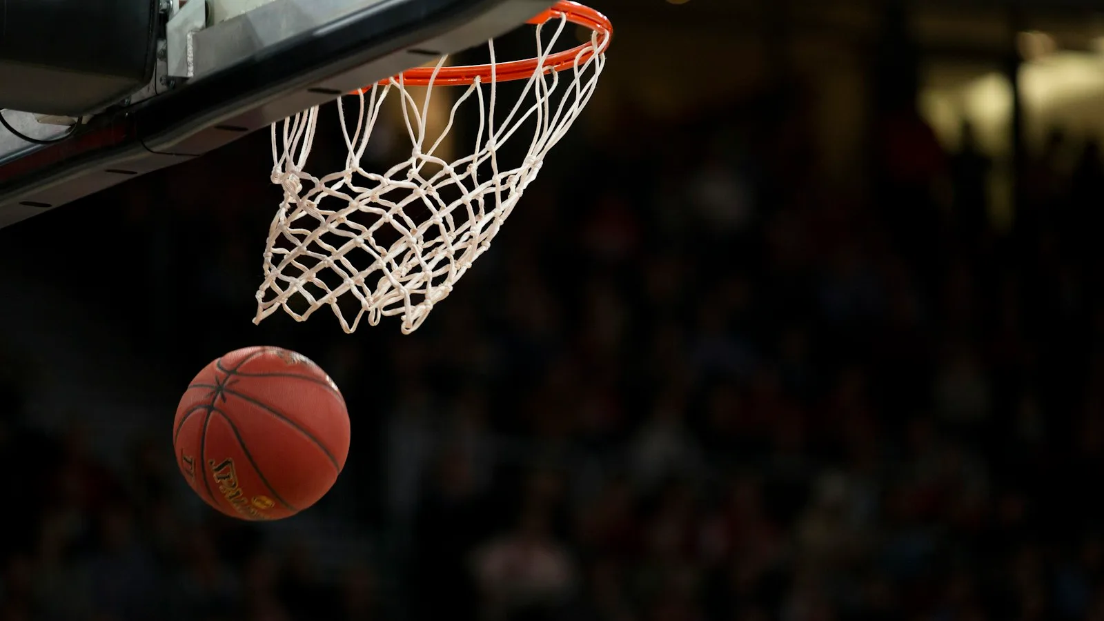 School basketball players competing in a brightly lit gymnasium